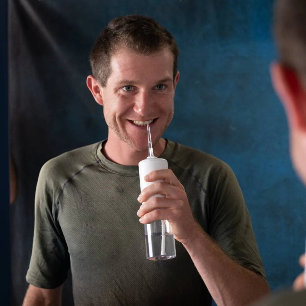 view of person using Hydro-One Water Flosser from Y-Brush