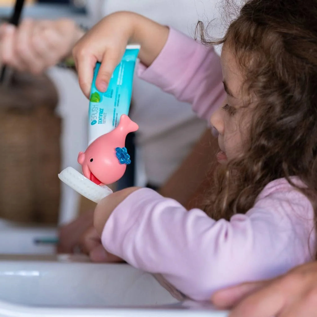 view of kid putting toothpaste on a New Y-Brush KidsBrush Sonic Electric Toothbrush (4-12 years old)